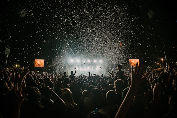 A stadium crowd under falling confetti